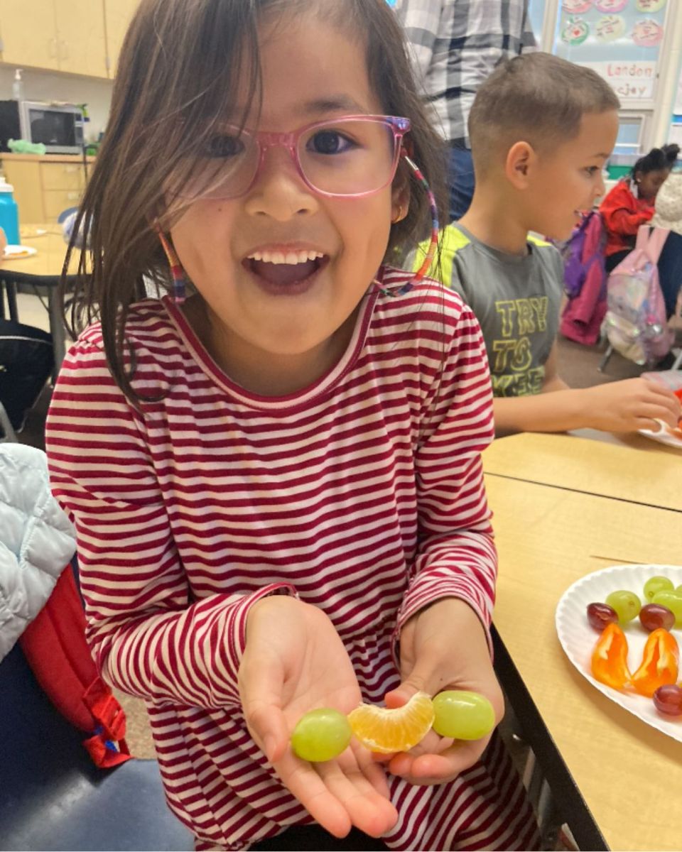 ClassStudentHoldingFruit